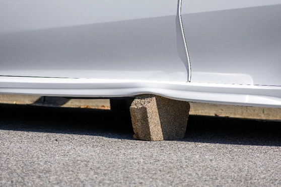 A stone under a parker car