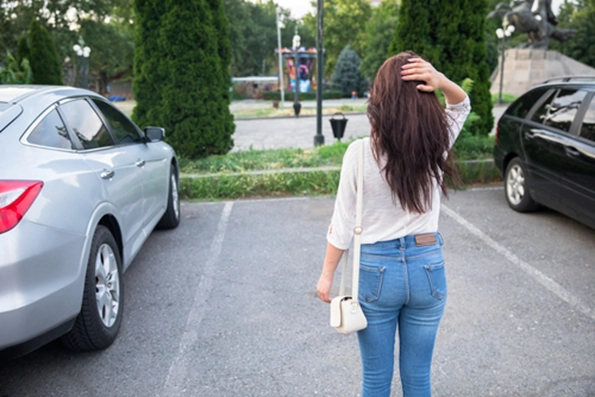 Woman standing in front of an empty car park space