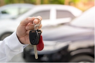 a hand holding car keys