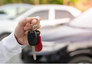 a hand holding car keys